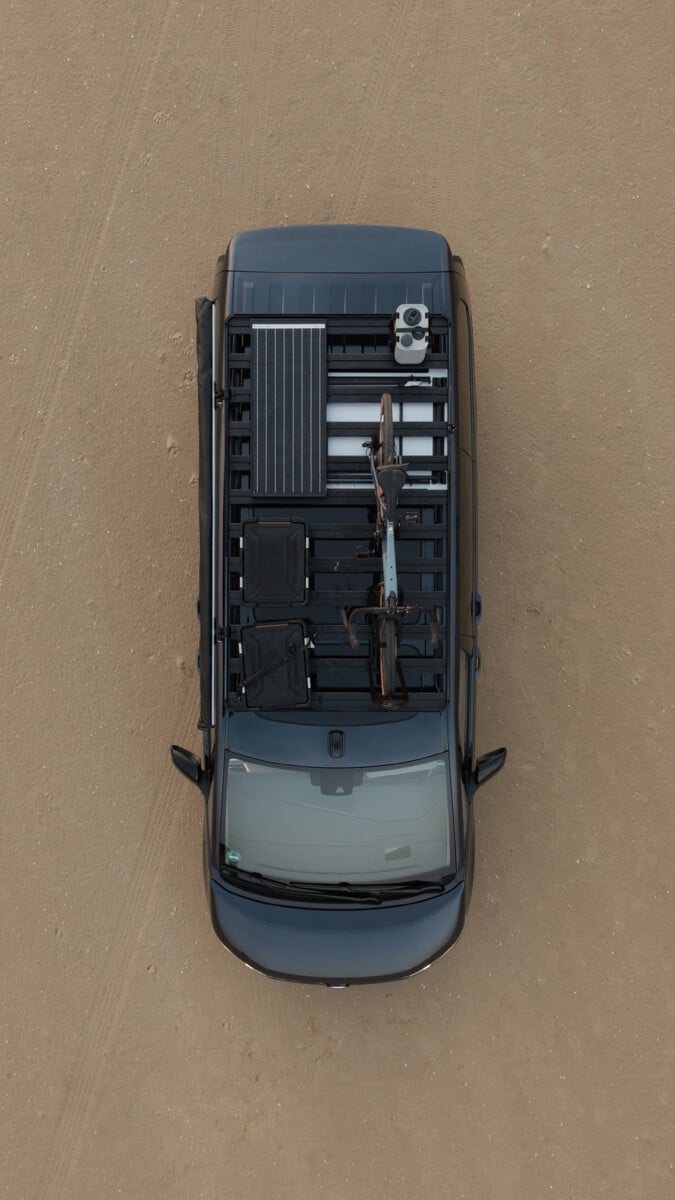 Roof rack viewed from above with recovery boards, utility accessories and mounted gear, showcasing accessory compatibility on a vehicle roof platform